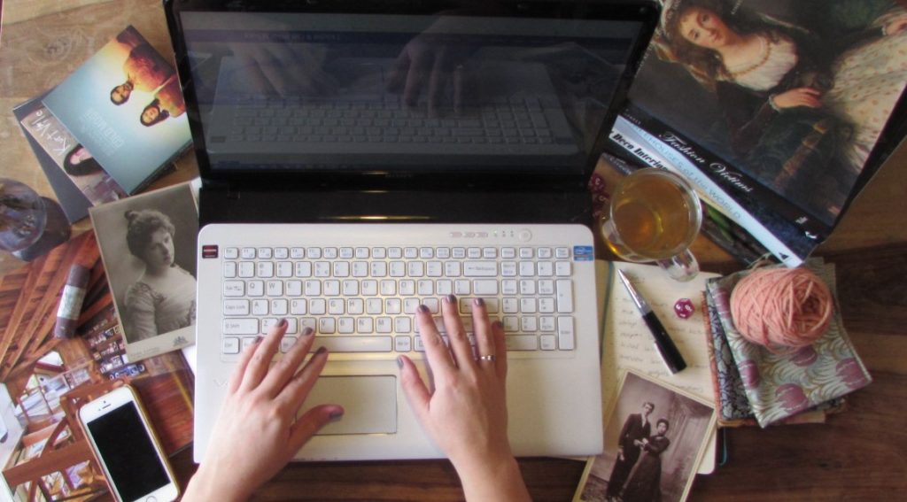 Kim Somberg typing on laptop