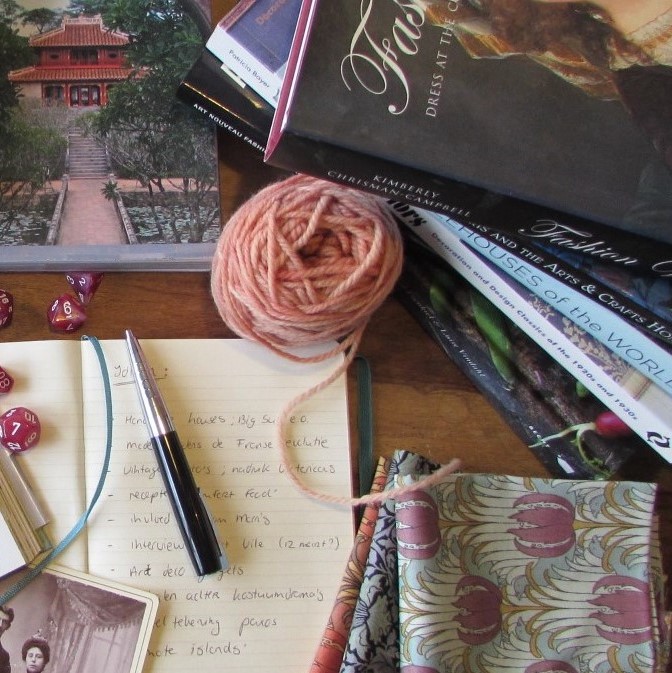 Books, wool, notebook, pen, fabrics, dice, old photo's square